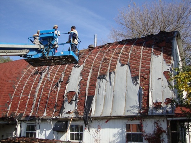 Fall, 2011, Primo Briano and Pollo Casique approach the tattered loft roof